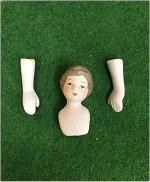 Painted Brown hair on a Porcelain Dolls head with arms 